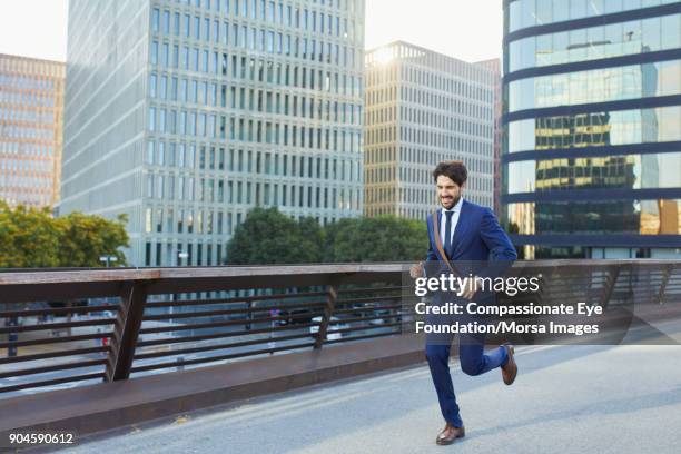 businessman running on city street - businessman running stock pictures, royalty-free photos & images