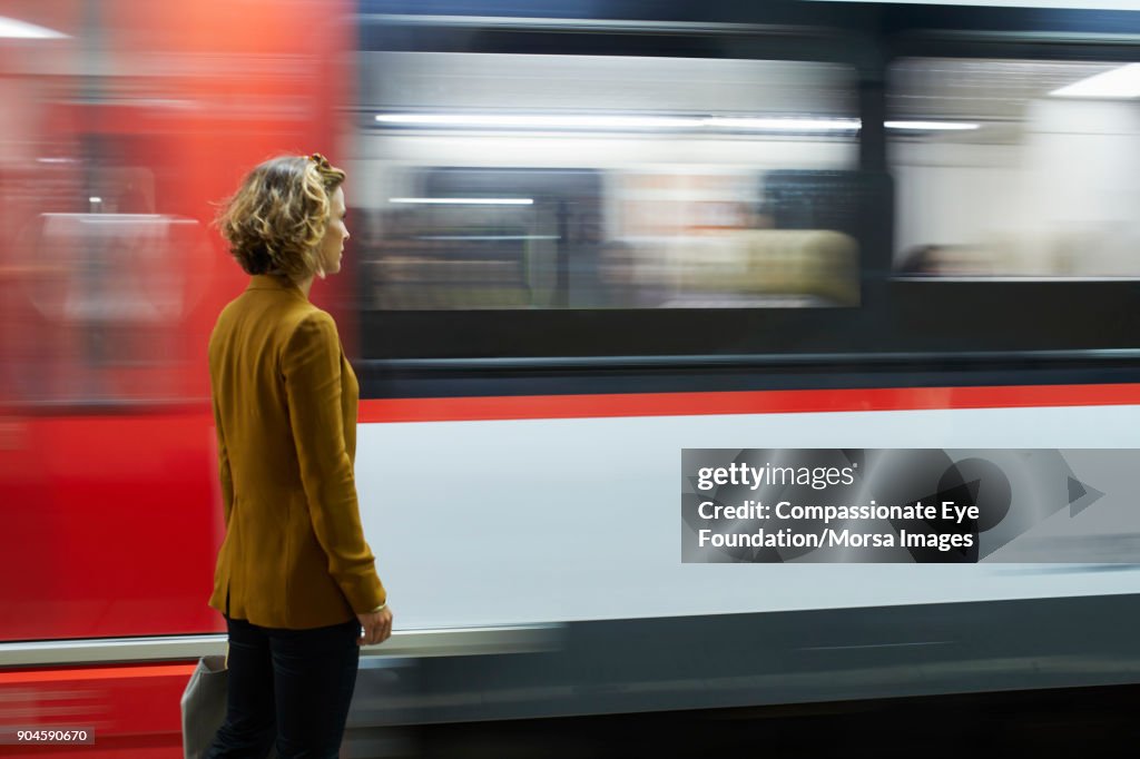 Businesswoman looking at subway train