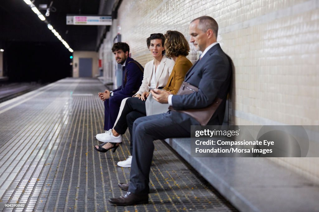 Business people waiting in subway station
