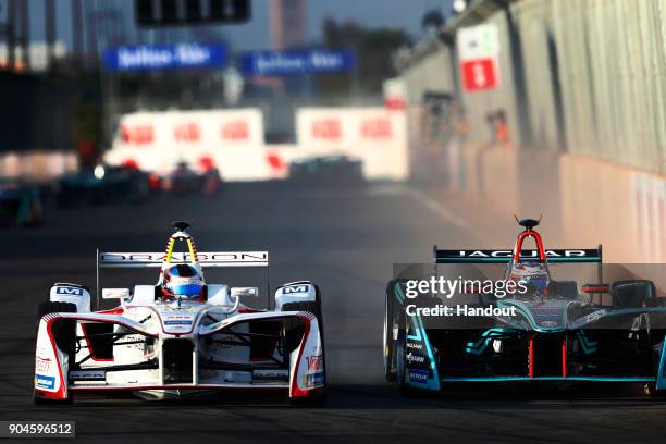 In this handout provided by FIA Formula E - Nick Heidfeld , Mahindra Racing, Mahindra M4Electro, battles with Mitch Evans , Panasonic Jaguar Racing,...