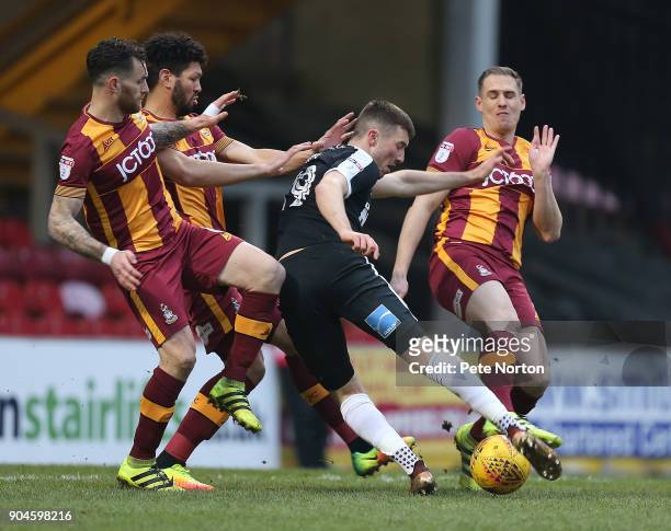 Chris Long of Northampton Town attempts to get a shot at goal away under pressure from Romain Vincelot, Nathaniel Kight-Percivall and Matthew...