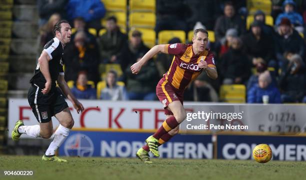 Matthew Kilgallon of Bradford City moves forward with the ball away from John-Joe O'Toole of Northampton Town during the Sky Bet League One match...