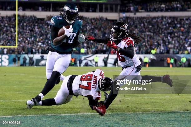 Running back LeGarrette Blount of the Philadelphia Eagles makes a 1-yard rush to score a touchdown against defensive tackle Grady Jarrett and strong...