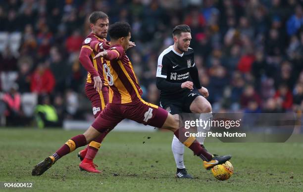 Matt Grimes of Northampton Town controlds the ball under pressure from Timothee Dieng of Bradford City during the Sky Bet League One match between...