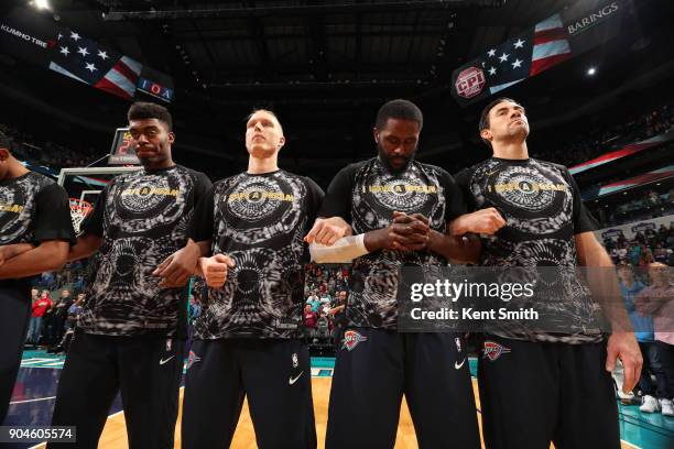 Dakari Johnson, Kyle Singler, Patrick Patterson and Nick Collison of the Oklahoma City Thunder stand for the National Anthem before the game against...