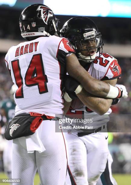 Running back Devonta Freeman of the Atlanta Falcons celebrates his touchdown with teammate wide receiver Justin Hardy against the Philadelphia Eagles...