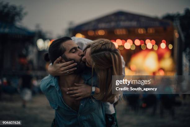 couple kissing on concert - festival of remembrance stock pictures, royalty-free photos & images