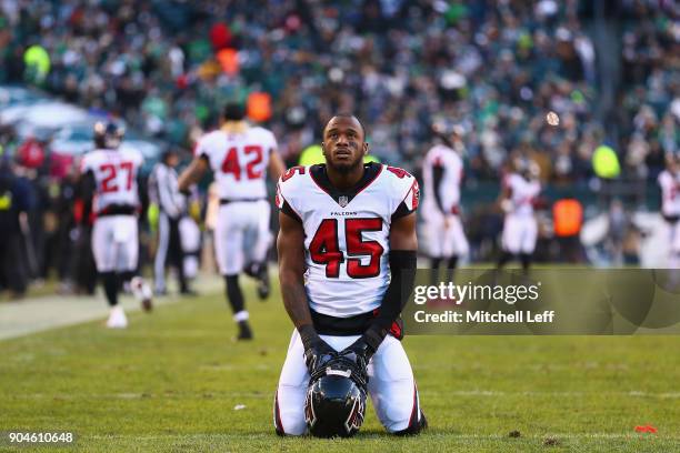 Middle linebacker Deion Jones of the Atlanta Falcons is seen on his knees before playing against the Philadelphia Eagles in the NFC Divisional...