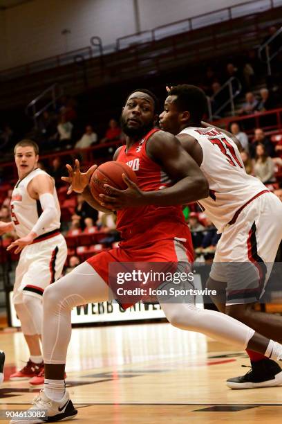 Randy Phillips center Radford University Highlanders pivots away from L'Hassane Niangane center Gardner-Webb University Runnin Bulldogs to score two...