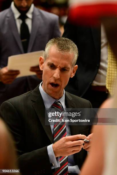 Tim Craft head coach Gardner-Webb University Runnin Bulldogs reviews strategies in a huddle during the game against the Radford University...