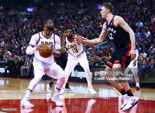 Dwyane Wade of the Cleveland Cavaliers dribbles the ball as Jakob Poeltl of the Toronto Raptors defends during the first half of an NBA game at Air...