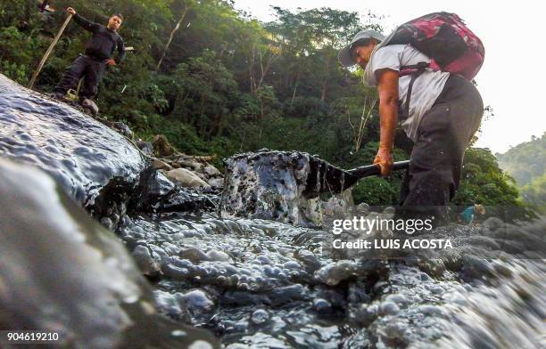 Emerald seeker Blanca Biutrago looks for the green gems in the Las Animas river close to an emerald mine in the municipality of Muzo - known as the...