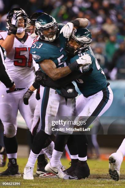 Outside linebacker Nigel Bradham of the Philadelphia Eagles celebrates with teammate defensive end Derek Barnett after sacking quarterback Matt Ryan...