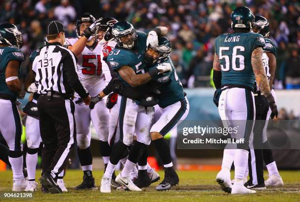 Outside linebacker Nigel Bradham of the Philadelphia Eagles celebrates with teammate defensive end Derek Barnett after sacking quarterback Matt Ryan...