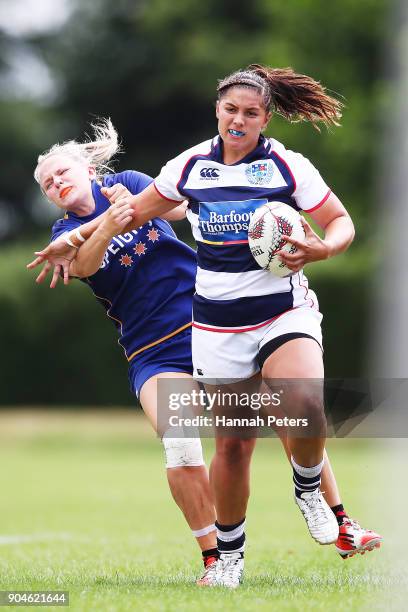 Lara Diamond-Brahne of Auckland fends off Zoey Flockton of Otago during the Bayleys National Sevens quarter final cup match between Otago and...