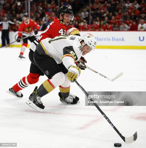 Cody Eakin of the Vegas Golden Knights reaches for the puck next to Gustav Forsling of the Chicago Blackhawks at the United Center on January 5, 2018...