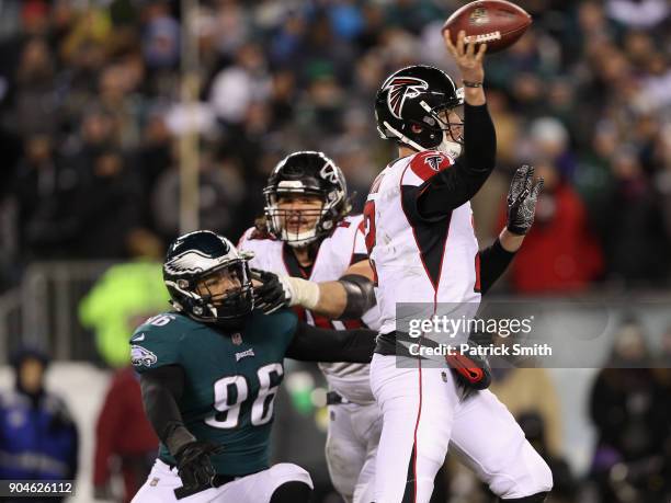 Quarterback Matt Ryan of the Atlanta Falcons attempts to throw a pass against defensive end Derek Barnett of the Philadelphia Eagles during the...