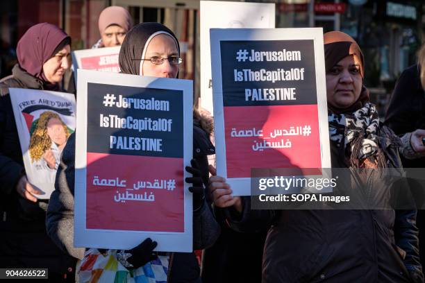 Placards are seen being displayed by the protesters. Demonstration of protest against the decision of Donald Trump, in violation of the international...