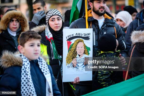 Female protester seen holding a placard during the protest. Demonstration of protest against the decision of Donald Trump, in violation of the...