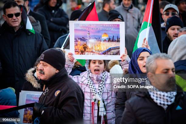 Young girl seen holding a placard during the protest. Demonstration of protest against the decision of Donald Trump, in violation of the...