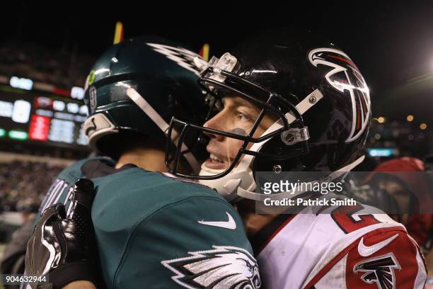 Nick Foles of the Philadelphia Eagles hugs Matt Ryan of the Atlanta Falcons after the NFC Divisional Playoff game at Lincoln Financial Field on...