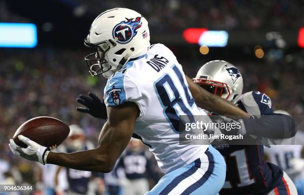 Corey Davis of the Tennessee Titans catches a touchdown pass as he is defended by Malcolm Butler of the New England Patriots in the first quarter of...