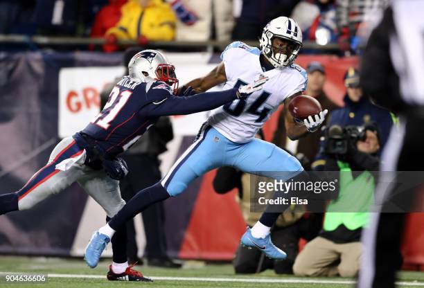 Corey Davis of the Tennessee Titans catches a touchdown pass as he is defended by Malcolm Butler of the New England Patriots in the first quarter of...