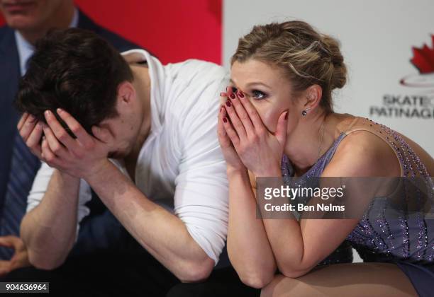 Kirsten Moore-Towers and Michael Marinaro of Canada await their score after competing in the free pair program during the 2018 Canadian Tire National...