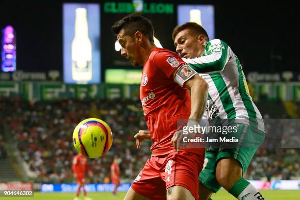 Rubens Sambueza of Toluca and Juan Cornejo of Leon fight for the ball during the second round match between Leon and Toluca as part of the Torneo...