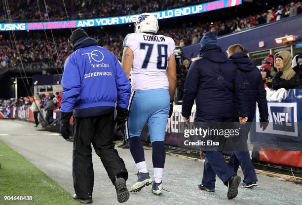 Jack Conklin of the Tennessee Titans walks off the field after an injury in the second quarter of the AFC Divisional Playoff game against the New...