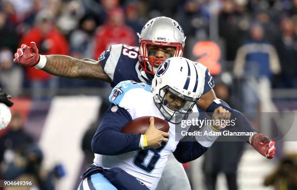 Marquis Flowers of the New England Patriots tackles Marcus Mariota of the Tennessee Titans in the third quarter of the AFC Divisional Playoff game at...