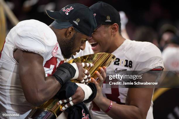 Rashaan Evans of the Alabama Crimson Tide hugs the trophy after defeating the Georgia Bulldogs during the College Football Playoff National...