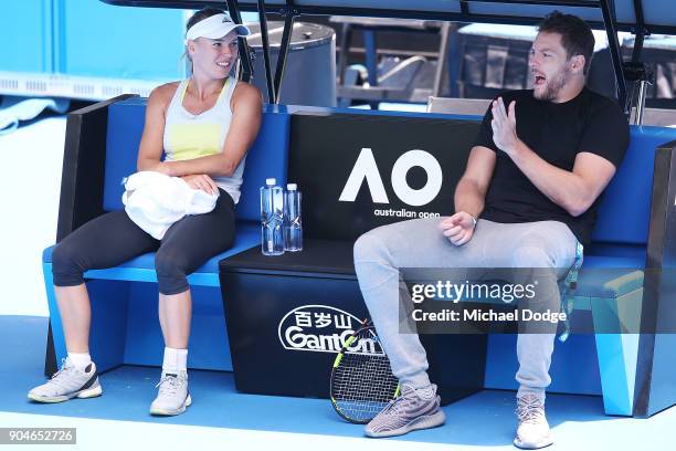 Caroline Wozniacki of Denmark talks with fiancee and former NBA player David Lee during a practice session ahead of the 2018 Australian Open at...