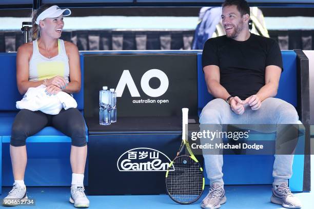 Caroline Wozniacki of Denmark talks with fiancee and former NBA player David Lee during a practice session ahead of the 2018 Australian Open at...