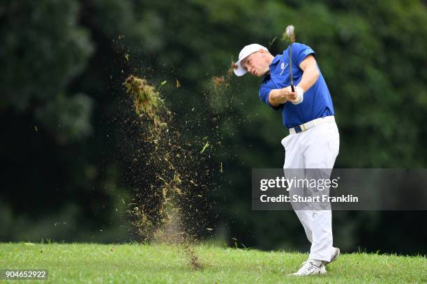 Alex Noren of Europe hits an approach shot on the 15th hole during the singles matches on day three of the 2018 EurAsia Cup presented by DRB-HICOM at...