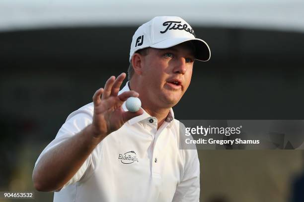 Tom Hoge of the United States reacts after making a birdie putt on the 18th green during round three of the Sony Open In Hawaii at Waialae Country...