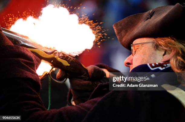 Member of the end zone militia fires a gun after a touchdown in the fourth quarter in the AFC Divisional Playoff game between the New England...