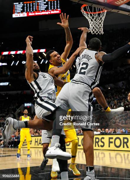Trey Lyles of the Denver Nuggets is stopped by Kawhi Leonard of the San Antonio Spurs and LaMarcus Aldridge of the San Antonio Spurs at AT&T Center...
