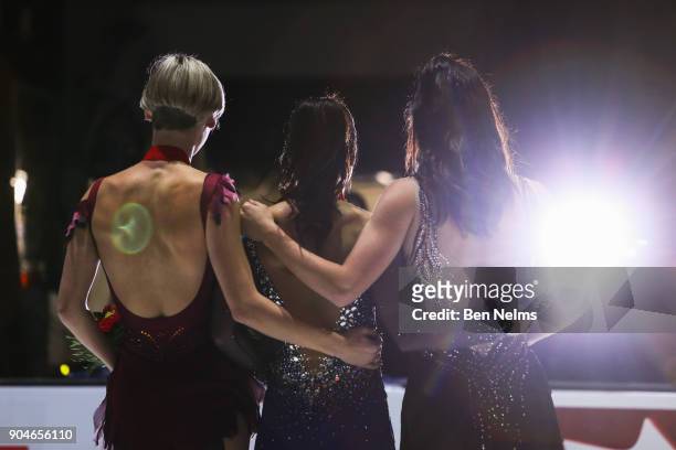 Gold Medalist Gabrielle Daleman, center, poses with silver medalist Kaetlyn Osmond, right, and Larkyn Austman, left, in the senior women's free...