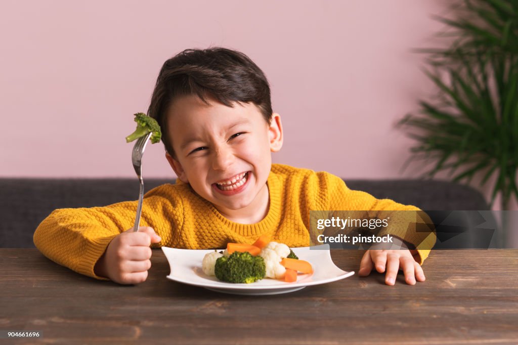 Child is eating vegetables.