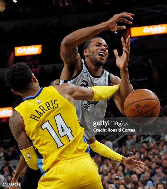 Kawhi Leonard of the San Antonio Spurs is fouled by Gary Harris of the Denver Nuggets at AT&T Center on January 13, 2018 in San Antonio, Texas. NOTE...