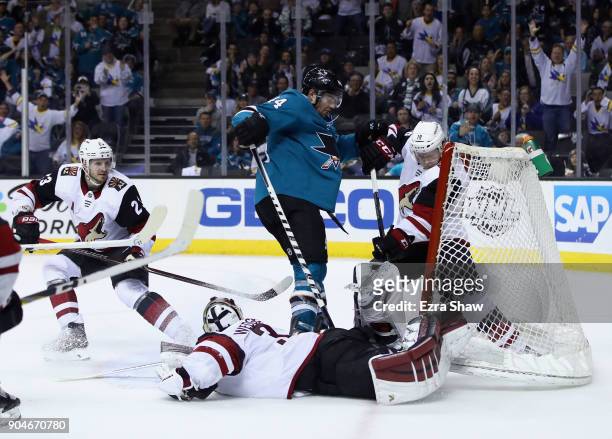 Marc-Edouard Vlasic of the San Jose Sharks scores the winning goal on Christian Dvorak and Scott Wedgewood of the Arizona Coyotes in overtime at SAP...