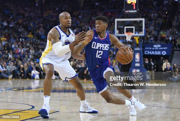Tyrone Wallace of the LA Clippers drives towards the basket on David West of the Golden State Warriors during the first half of their NBA Basketball...