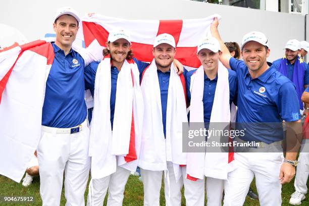 Ross Fisher, Tommy Fleetwood, Tyrrell Hatton, Matthew Fitzpatrick and Paul Casey of Europe celebrate with an England flag after their teams victory...