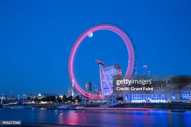 evening view of famous ride. - london eye stock pictures, royalty-free photos & images
