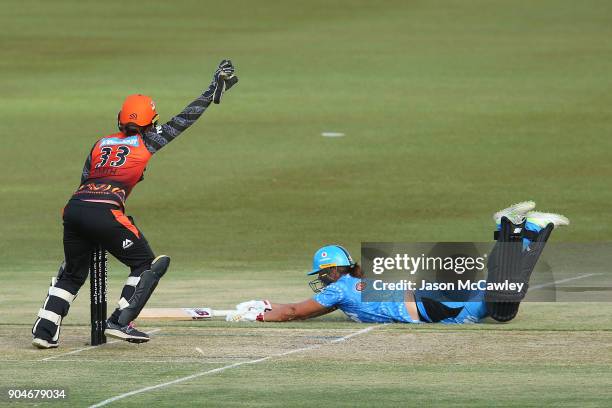 Emily Smith of the Scorchers attempts to run out Suzie Bates of the Strikers during the Women's Big Bash League match between the Perth Scorchers and...