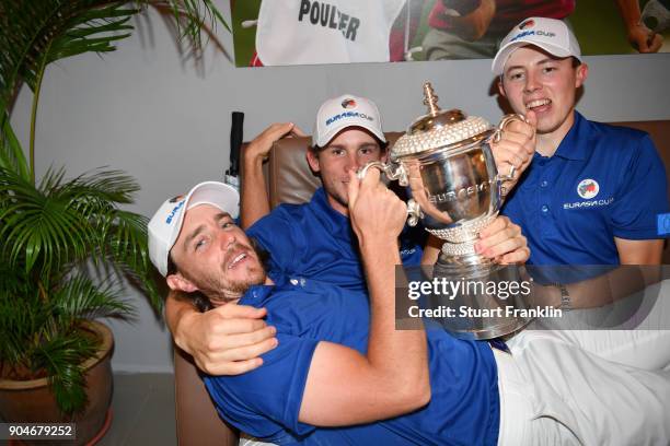 Tommy Fleetwood, Thomas Pieters and Matthew Fitzpatrick of Europe celebrate with the trophy following their team's victory during the singles matches...