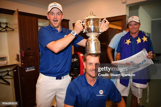 Bernd Wiesberger of Europe poses with the trophy and Henrik Stenson following his team's victory during the singles matches on day three of the 2018...