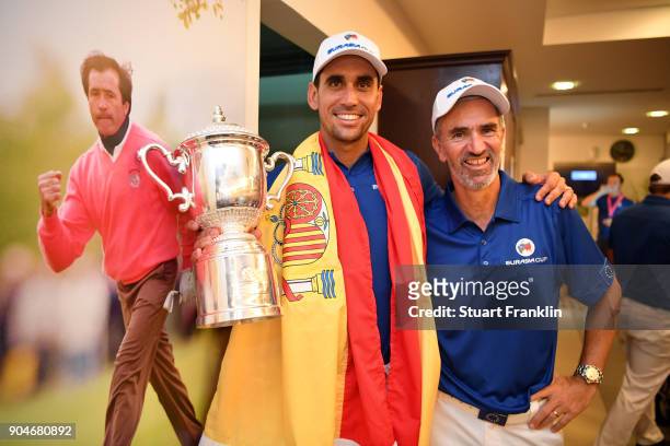 Rafa Cabrera-Bello of Europe celebrates with the trophy and caddie Colin Byrne following his team's victory during the singles matches on day three...