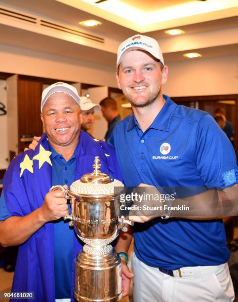 Bernd Wiesberger of Europe poses with the trophy and his caddie following his team's victory during the singles matches on day three of the 2018...